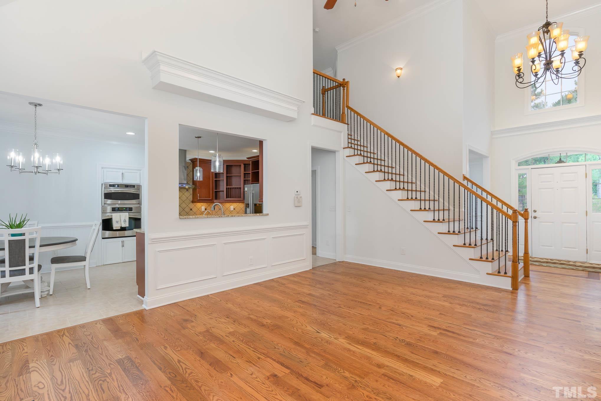 320 Government Road Clayton, NC 27520 - Photo 13 of 48 a view of a hallway with wooden floor and staircase