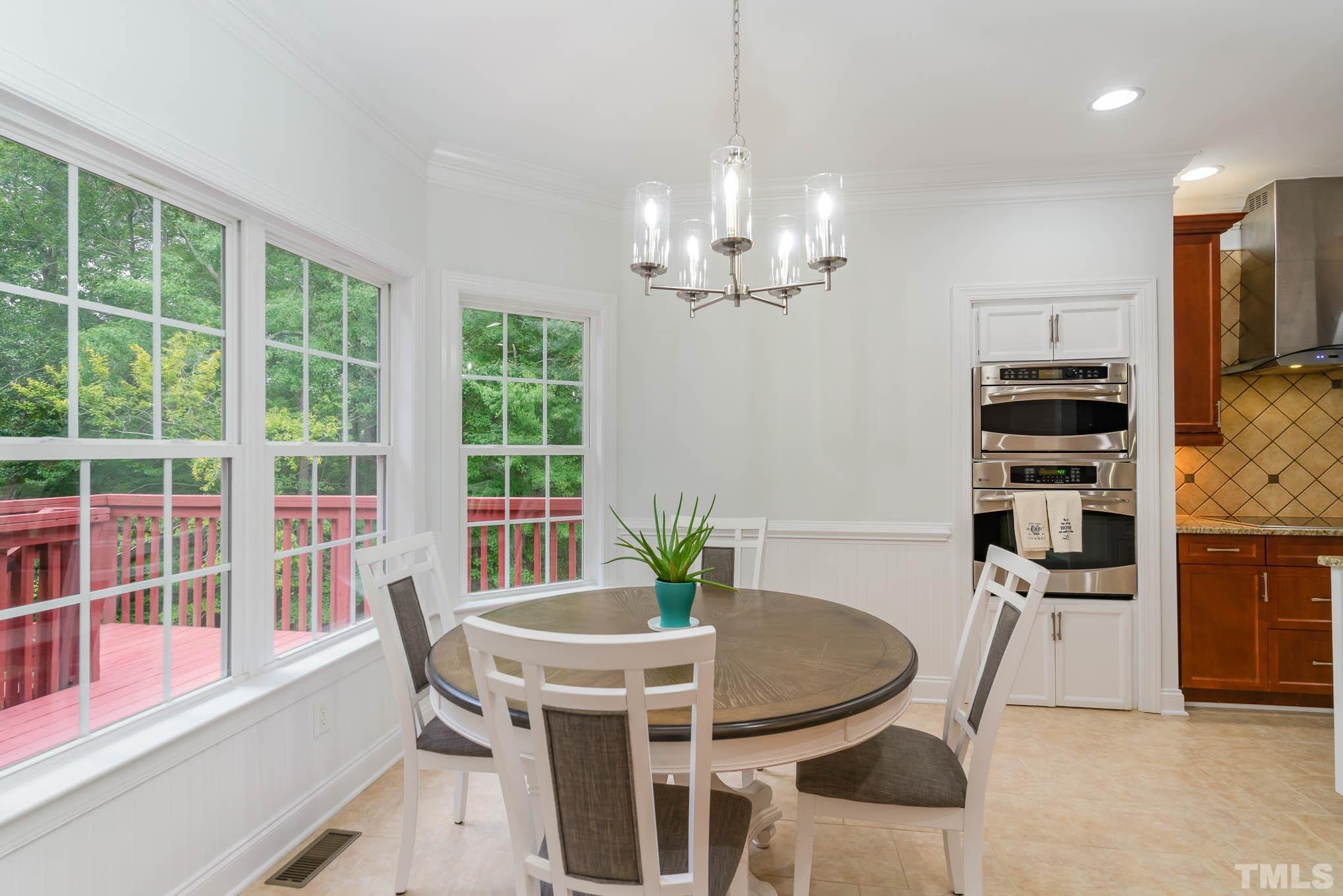 320 Government Road Clayton, NC 27520 - Photo 14 of 48 a view of a dining room with furniture large windows and wooden floor