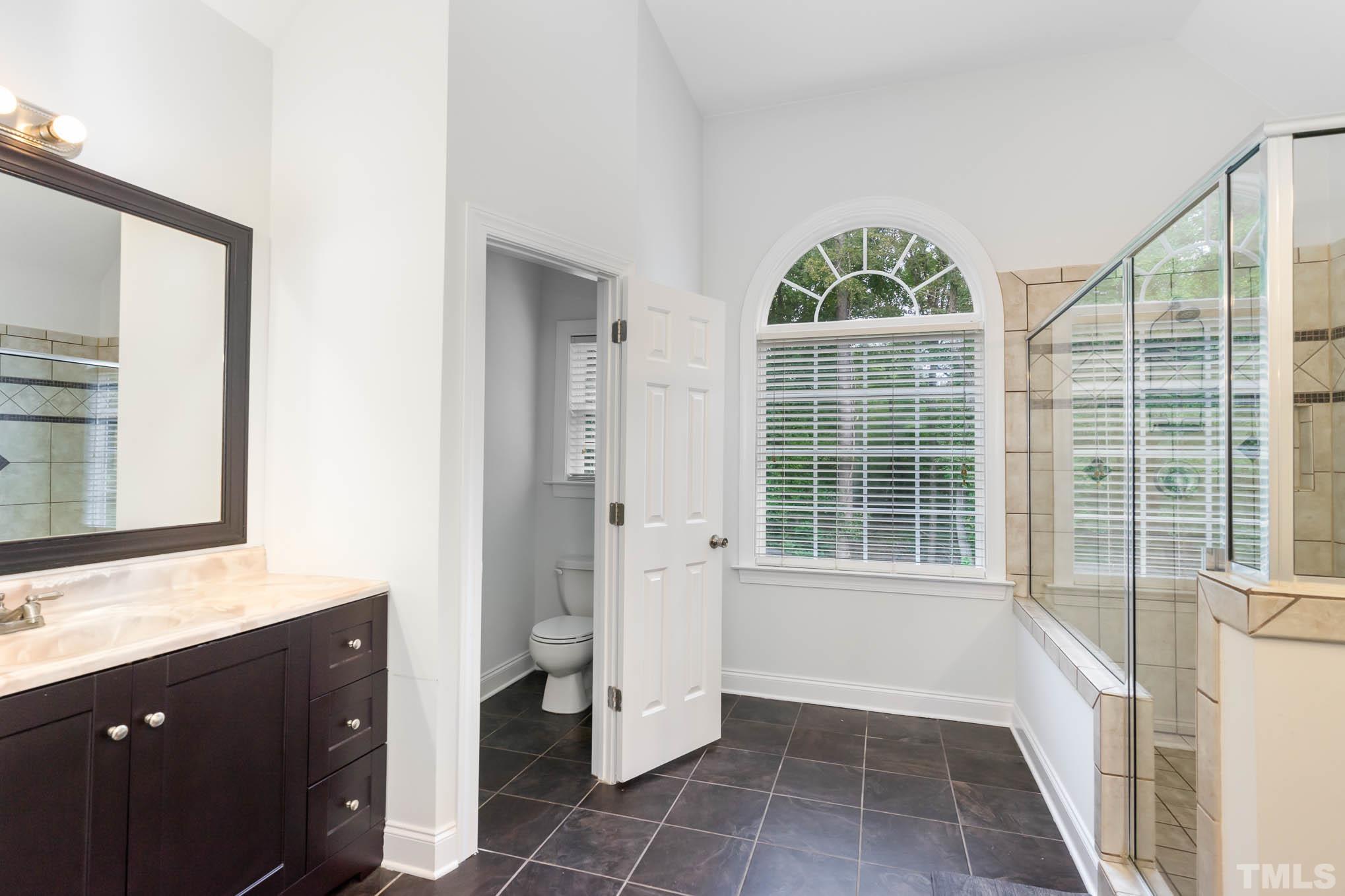 320 Government Road Clayton, NC 27520 - Photo 19 of 48 a bathroom with a bathtub and a sink
