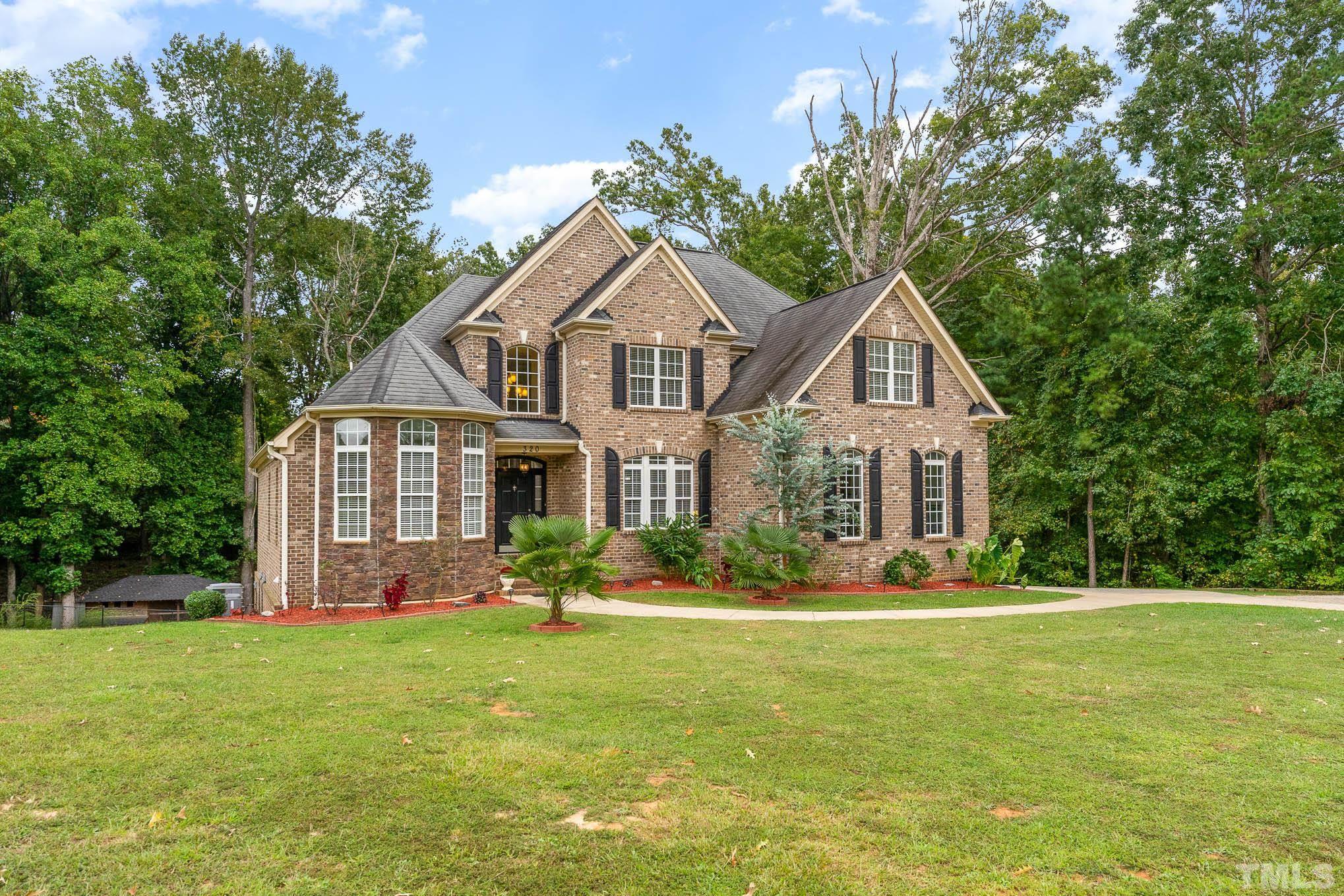 320 Government Road Clayton, NC 27520 - Photo 2 of 48 a front view of a house with a yard