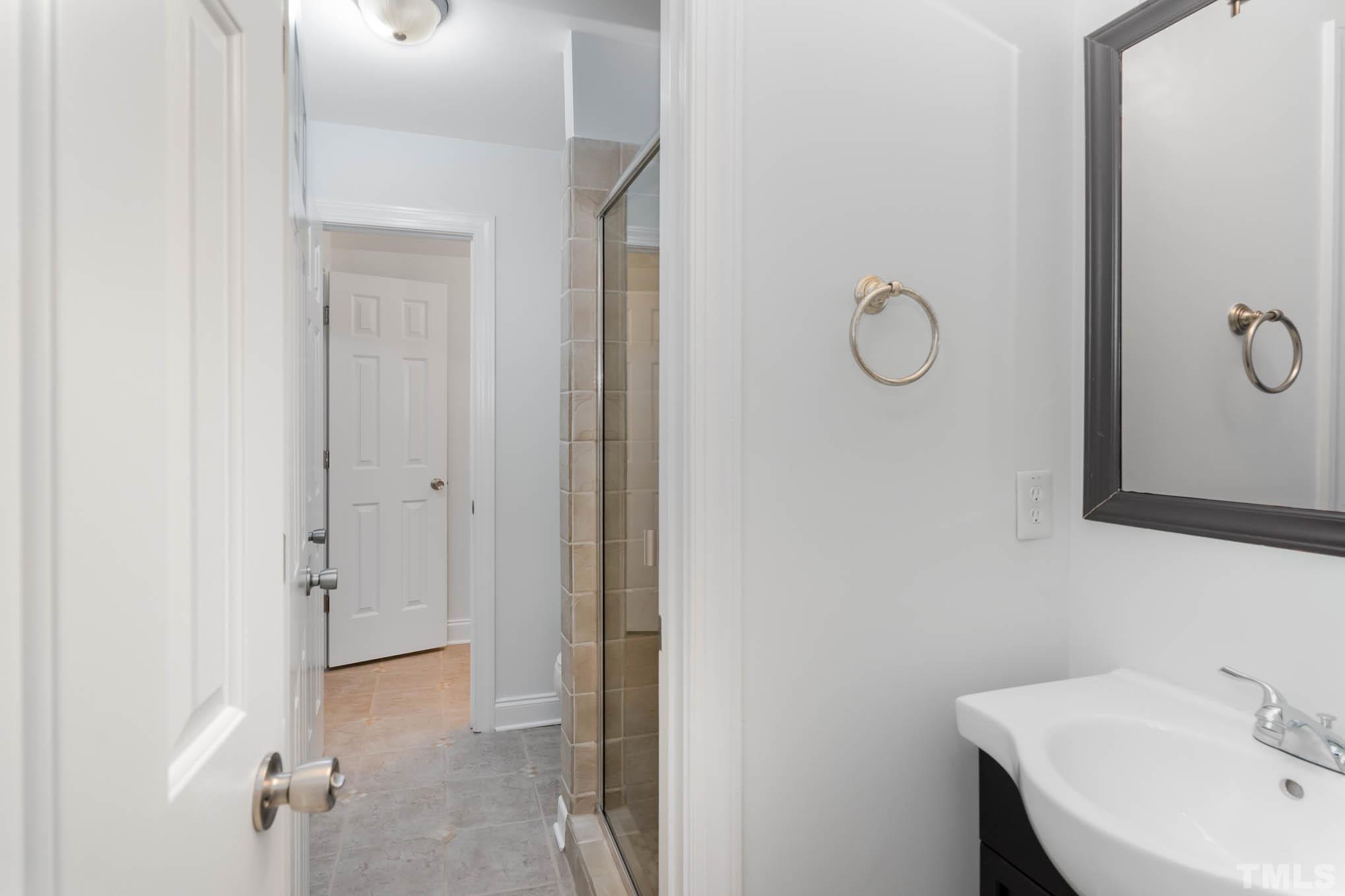320 Government Road Clayton, NC 27520 - Photo 27 of 48 a bathroom with a sink and mirror