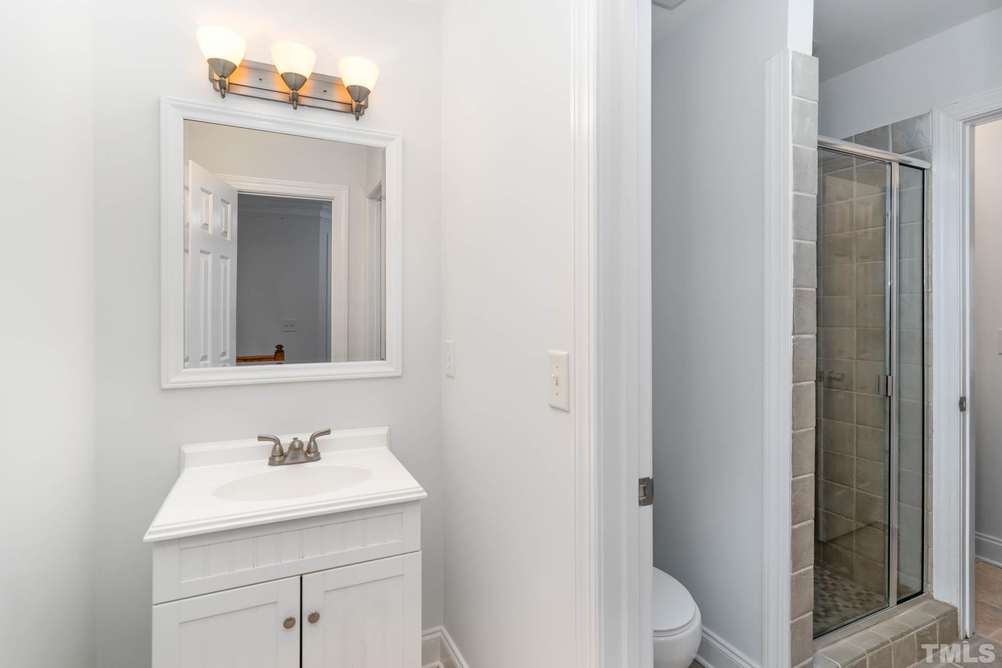 320 Government Road Clayton, NC 27520 - Photo 28 of 48 a bathroom with a sink toilet and vanity