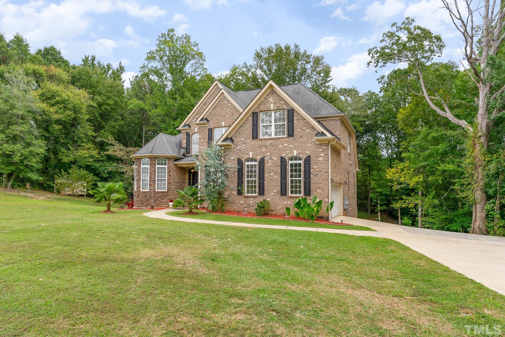 320 Government Road Clayton, NC 27520 - Photo 3 of 48 a front view of a house with a yard and trees