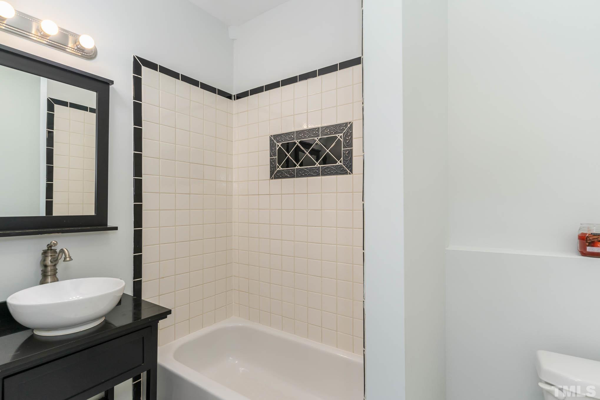 320 Government Road Clayton, NC 27520 - Photo 33 of 48 a bathroom with a sink a toilet and a bathtub