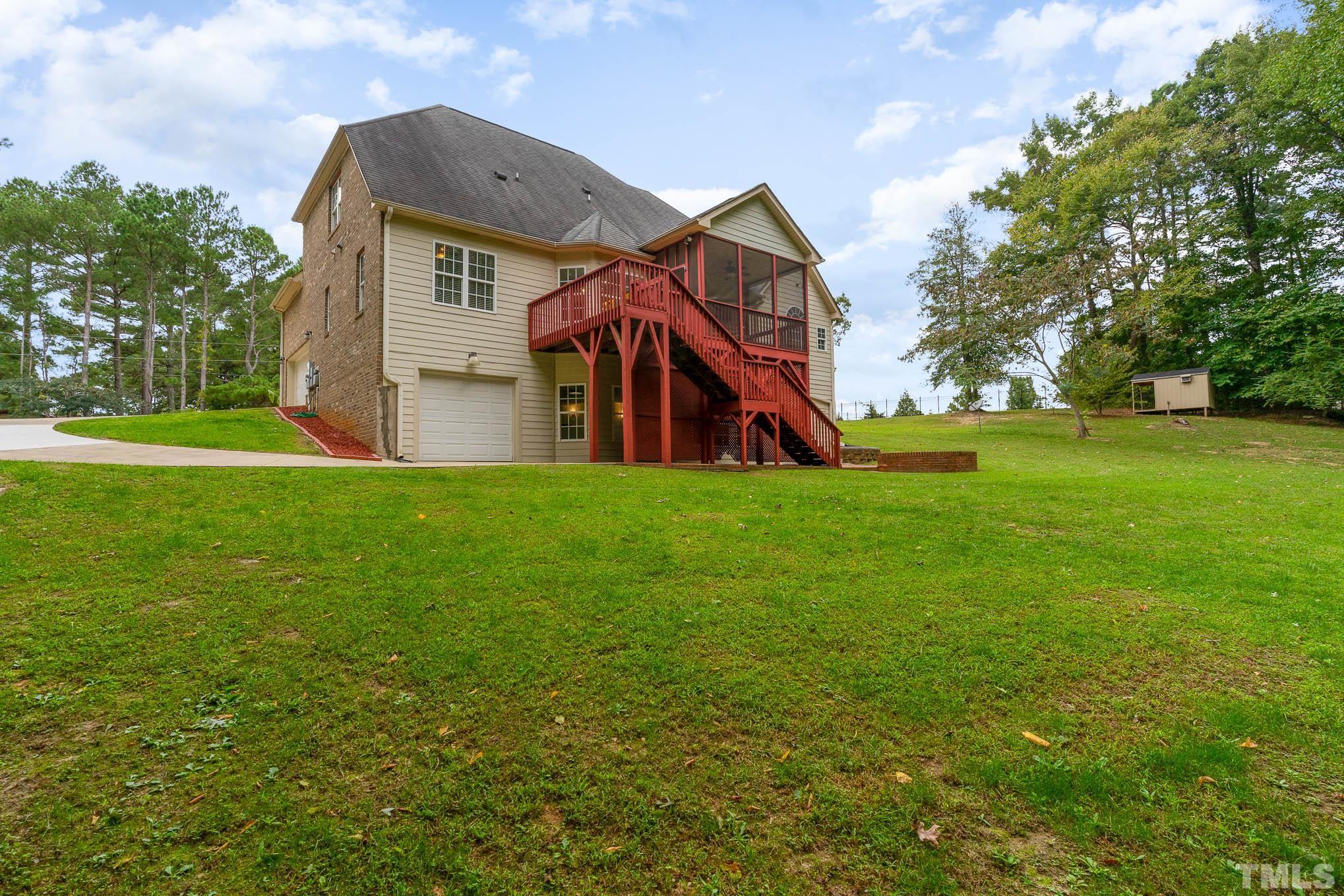320 Government Road Clayton, NC 27520 - Photo 43 of 48 a view of a house with a big yard and large trees