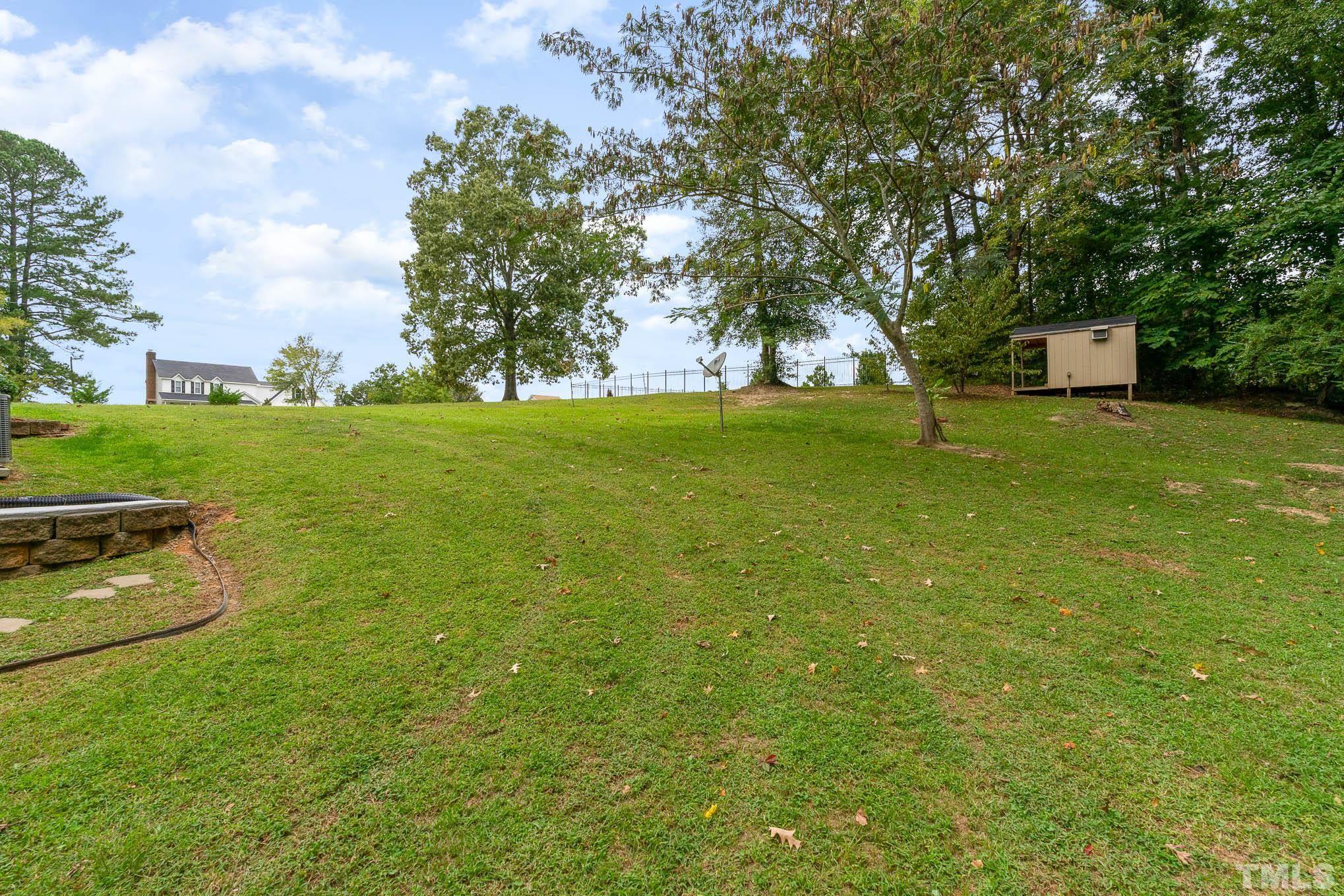 320 Government Road Clayton, NC 27520 - Photo 48 of 48 a backyard of a house with lots of green space and garden view