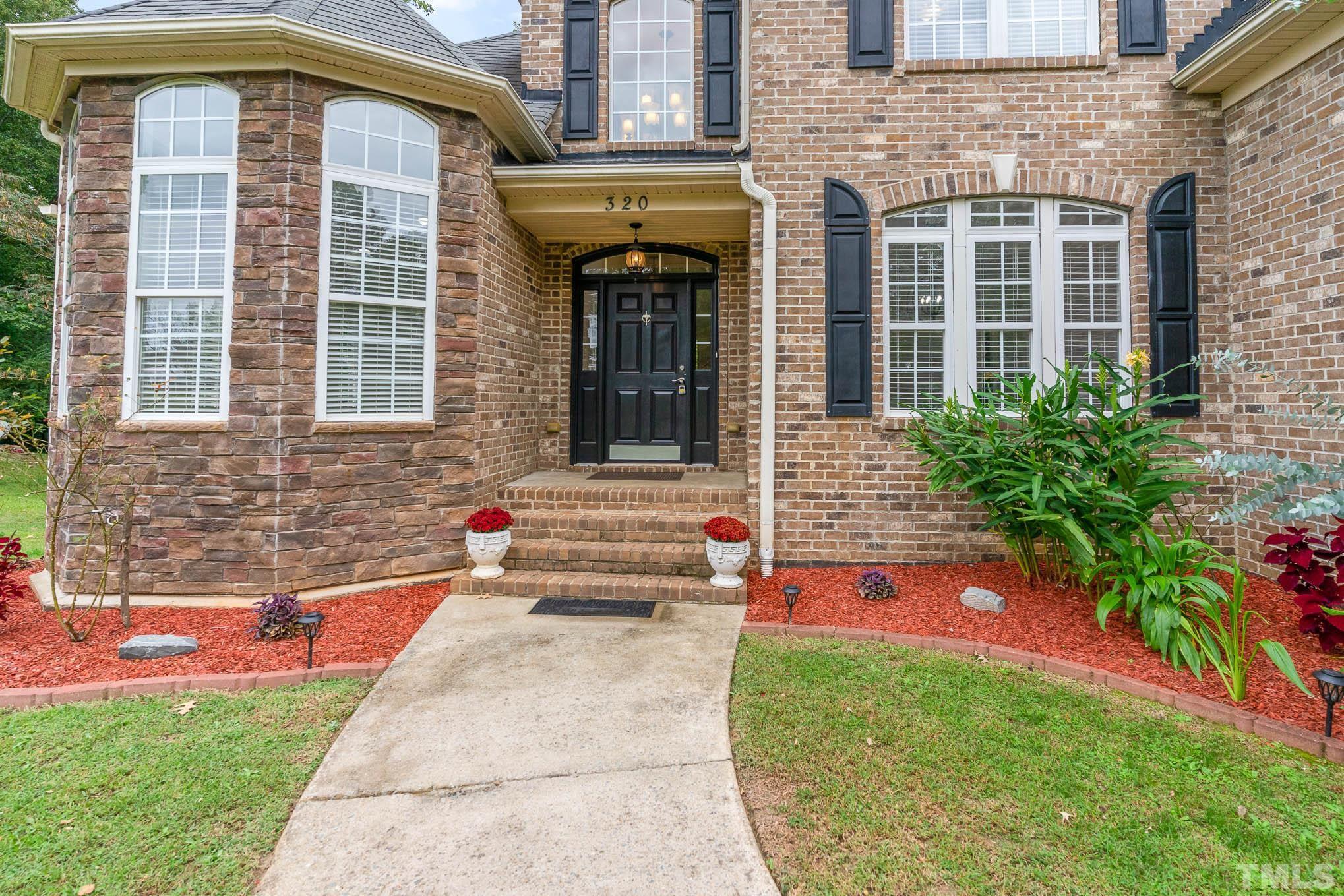 320 Government Road Clayton, NC 27520 - Photo 7 of 48 a front view of a house with a yard