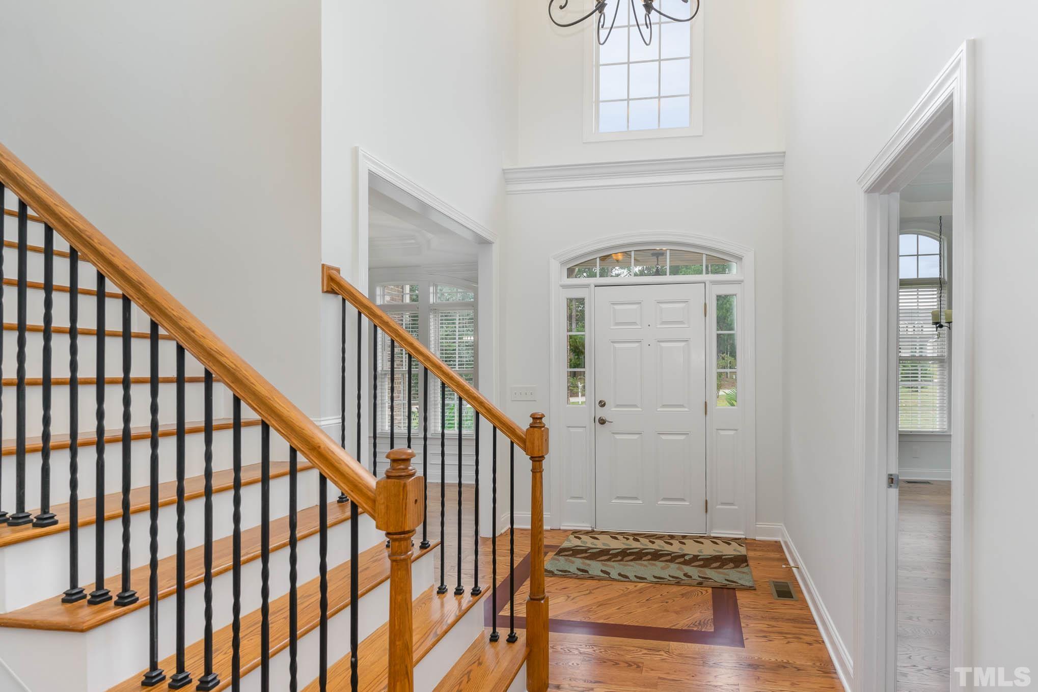 320 Government Road Clayton, NC 27520 - Photo 8 of 48 a view of a hallway with wooden floor and staircase