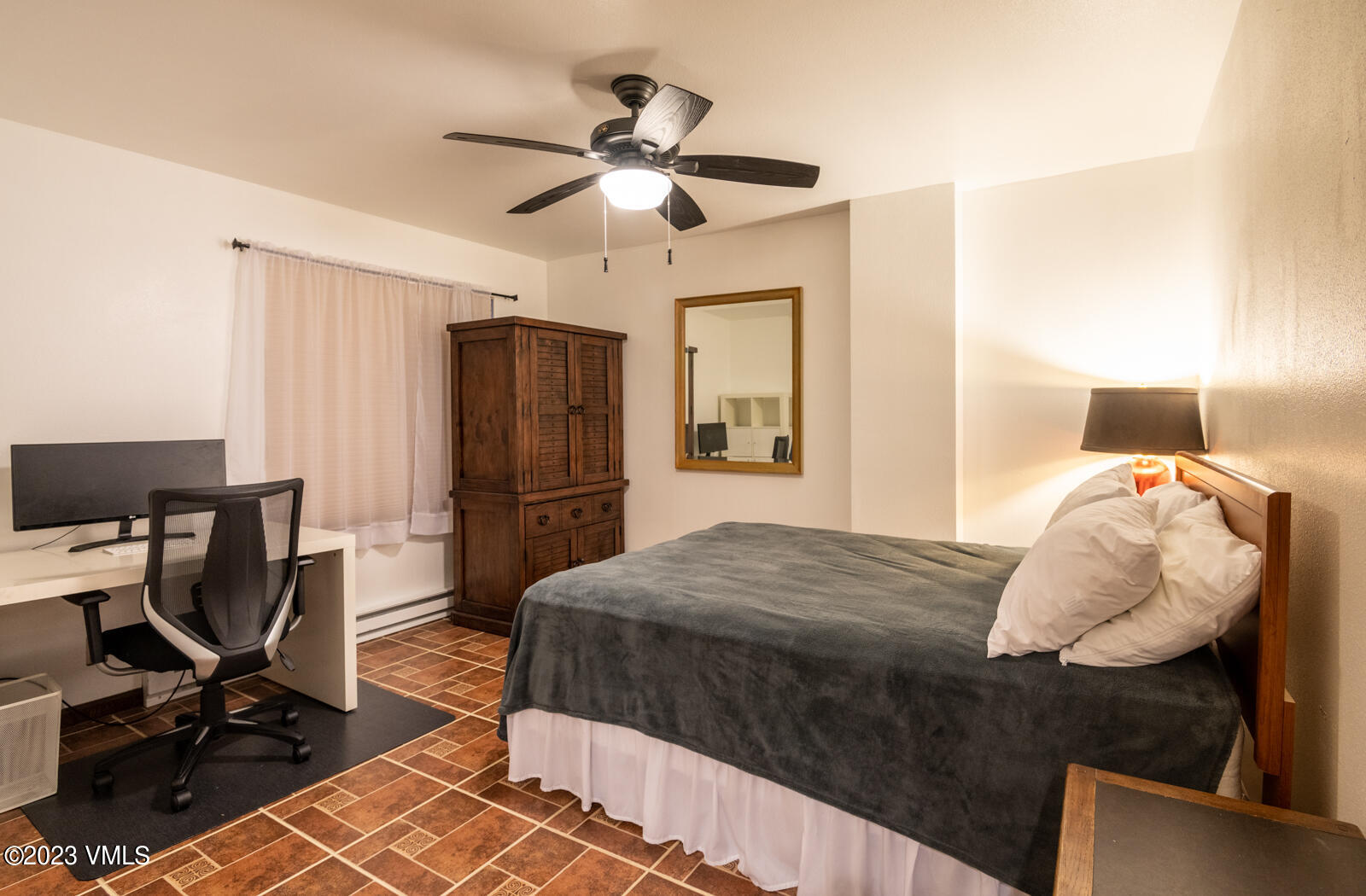 137 Benchmark Road, Unit 209 Avon, CO 81620 - Photo 12 of 20 a bedroom with a bed and a chandelier