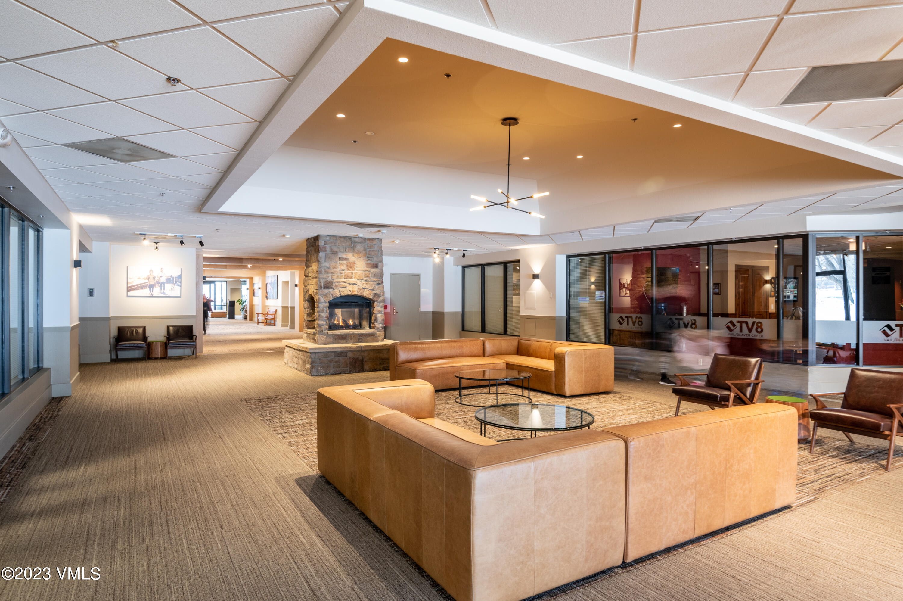 137 Benchmark Road, Unit 209 Avon, CO 81620 - Photo 18 of 20 a living room with furniture and a chandelier