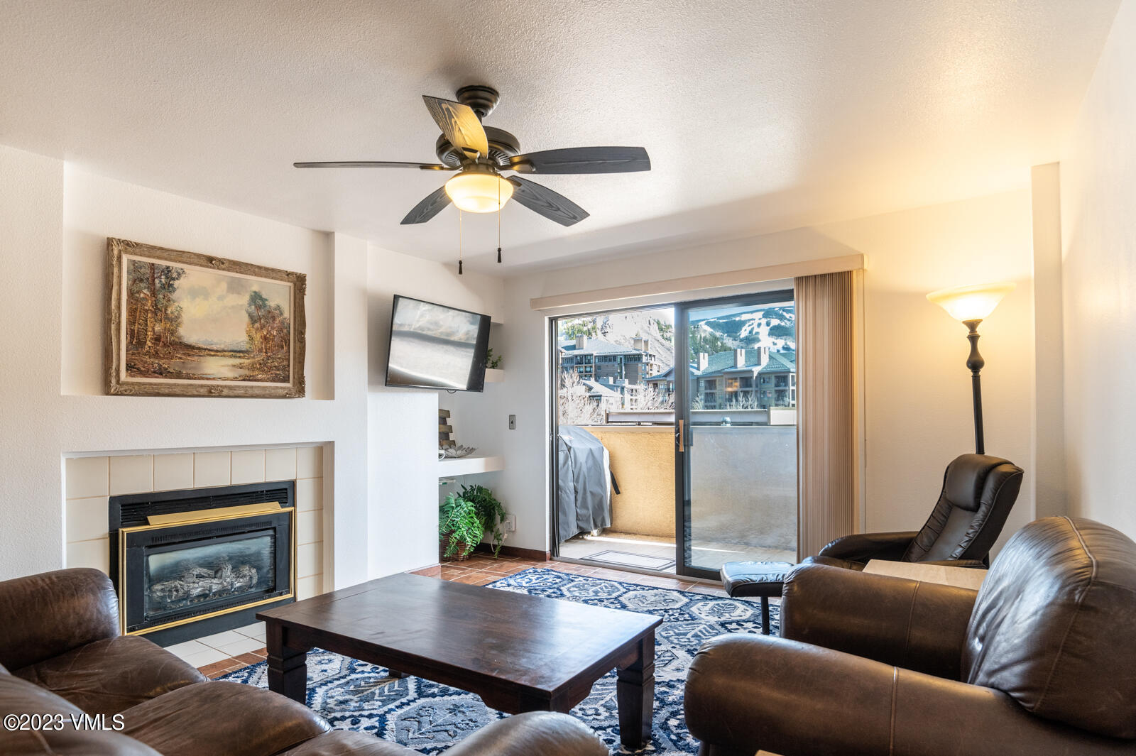 137 Benchmark Road, Unit 209 Avon, CO 81620 - Photo 3 of 20 a living room with furniture wooden floor and a fireplace