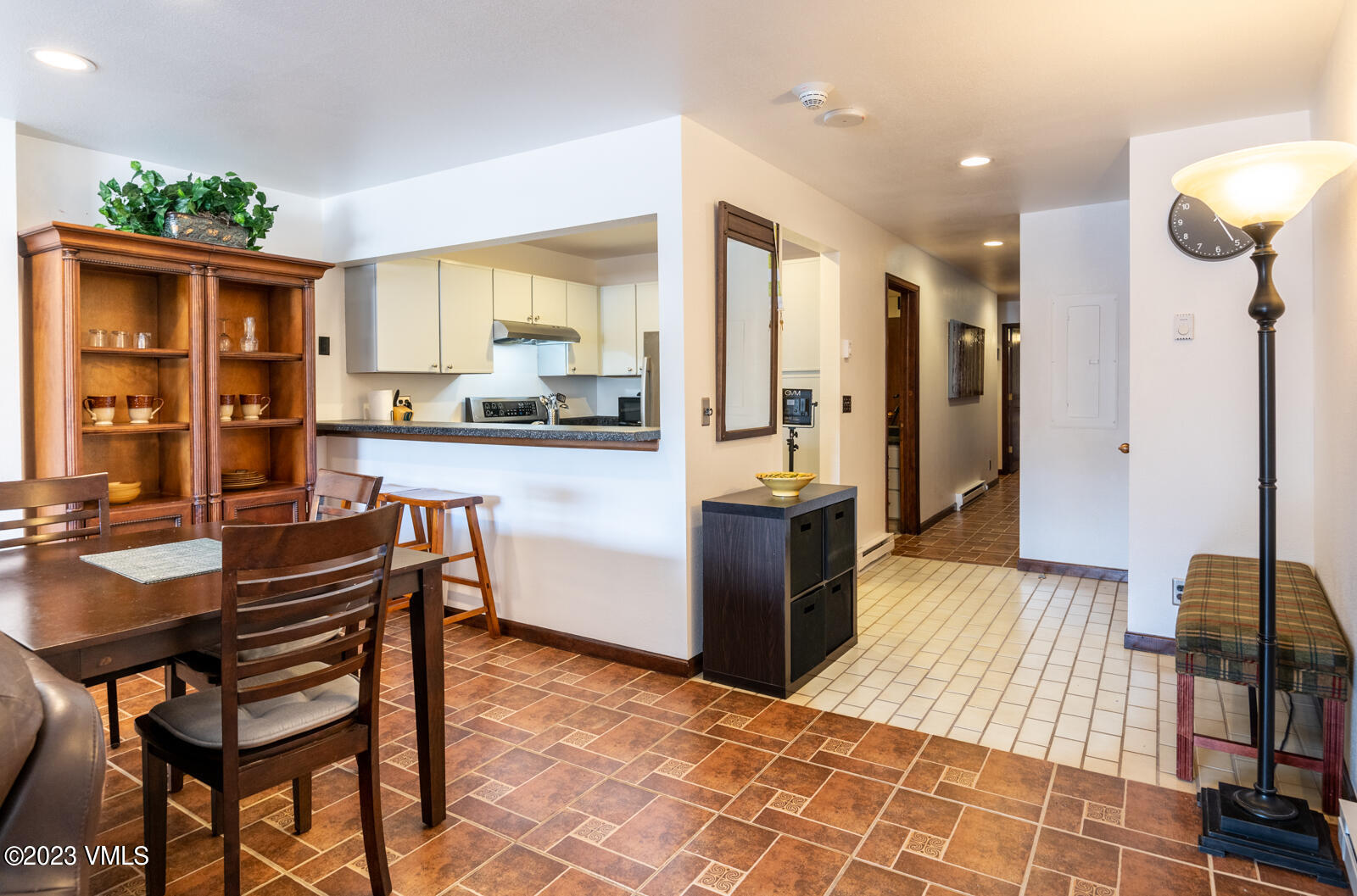 137 Benchmark Road, Unit 209 Avon, CO 81620 - Photo 6 of 20 a kitchen with stainless steel appliances kitchen island granite countertop dining table chairs and a refrigerator