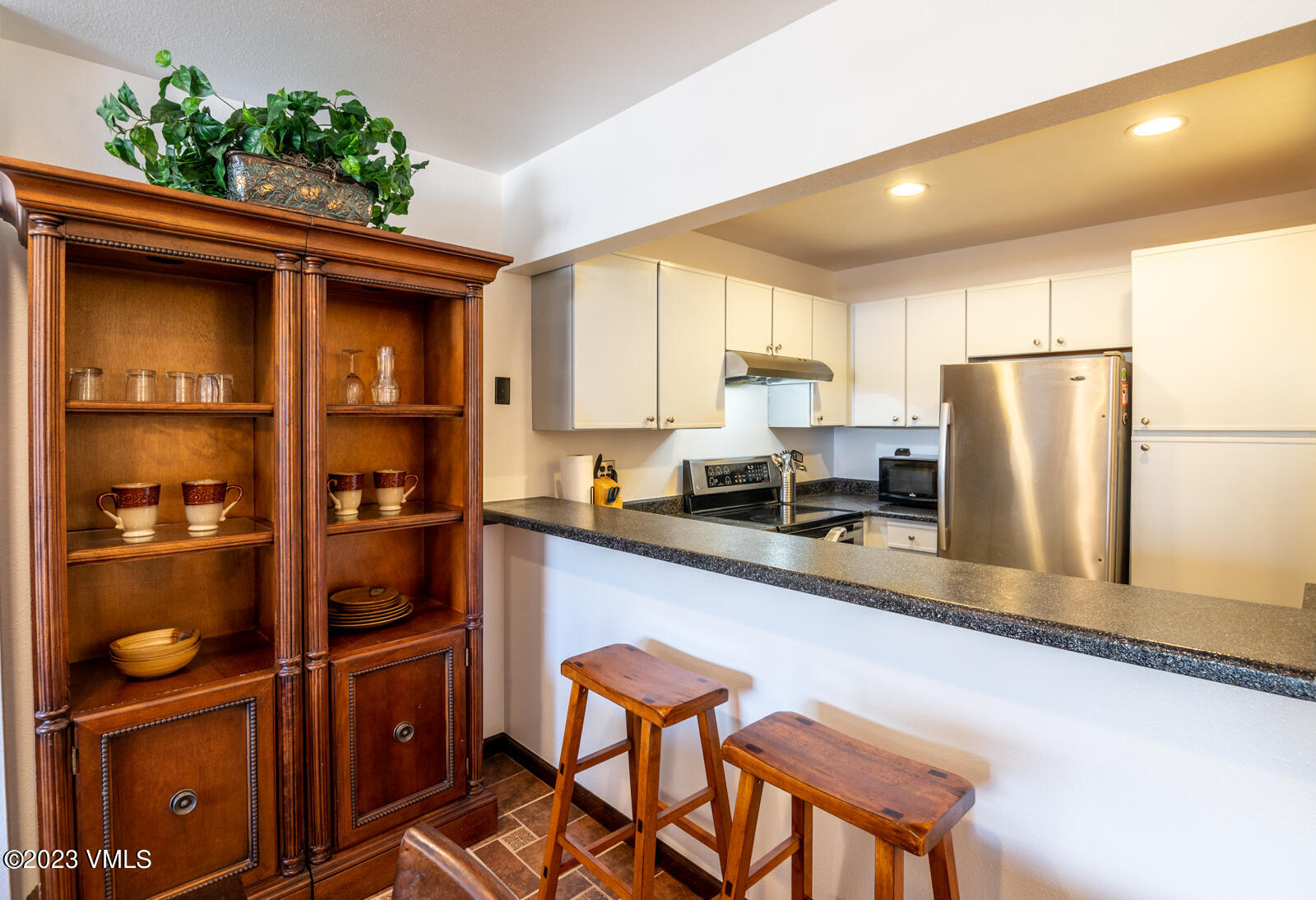 137 Benchmark Road, Unit 209 Avon, CO 81620 - Photo 7 of 20 a kitchen with stainless steel appliances granite countertop a refrigerator and a stove top oven