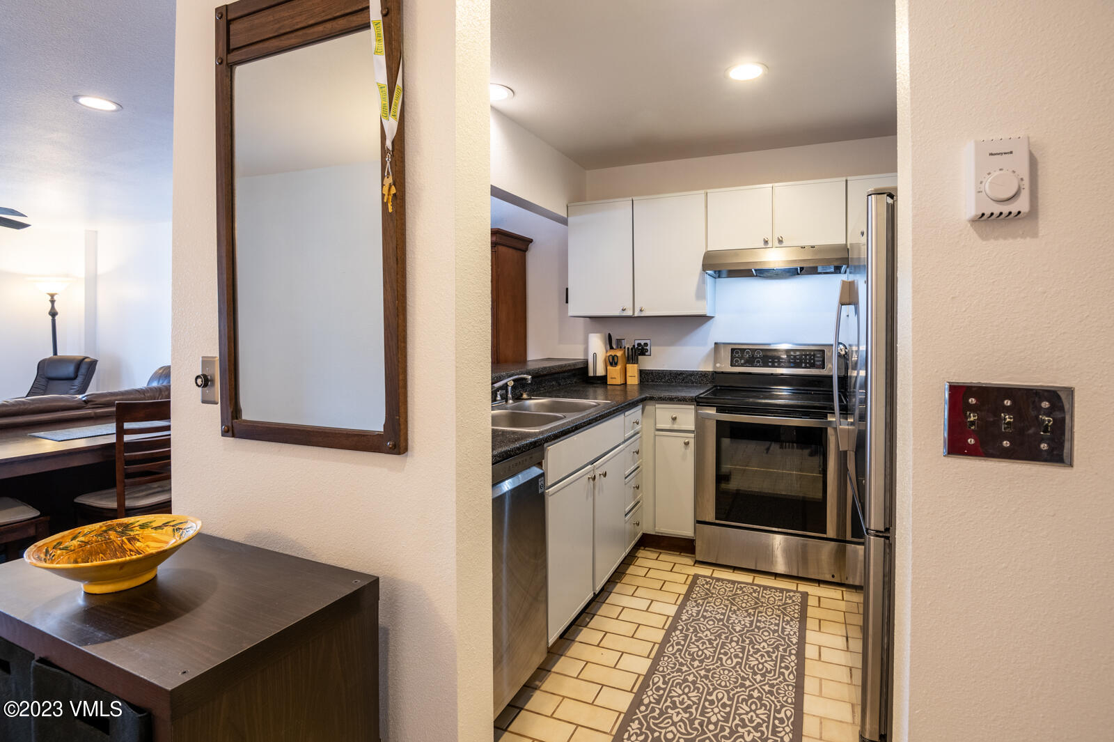 137 Benchmark Road, Unit 209 Avon, CO 81620 - Photo 9 of 20 a kitchen with stainless steel appliances granite countertop a refrigerator and a stove top oven