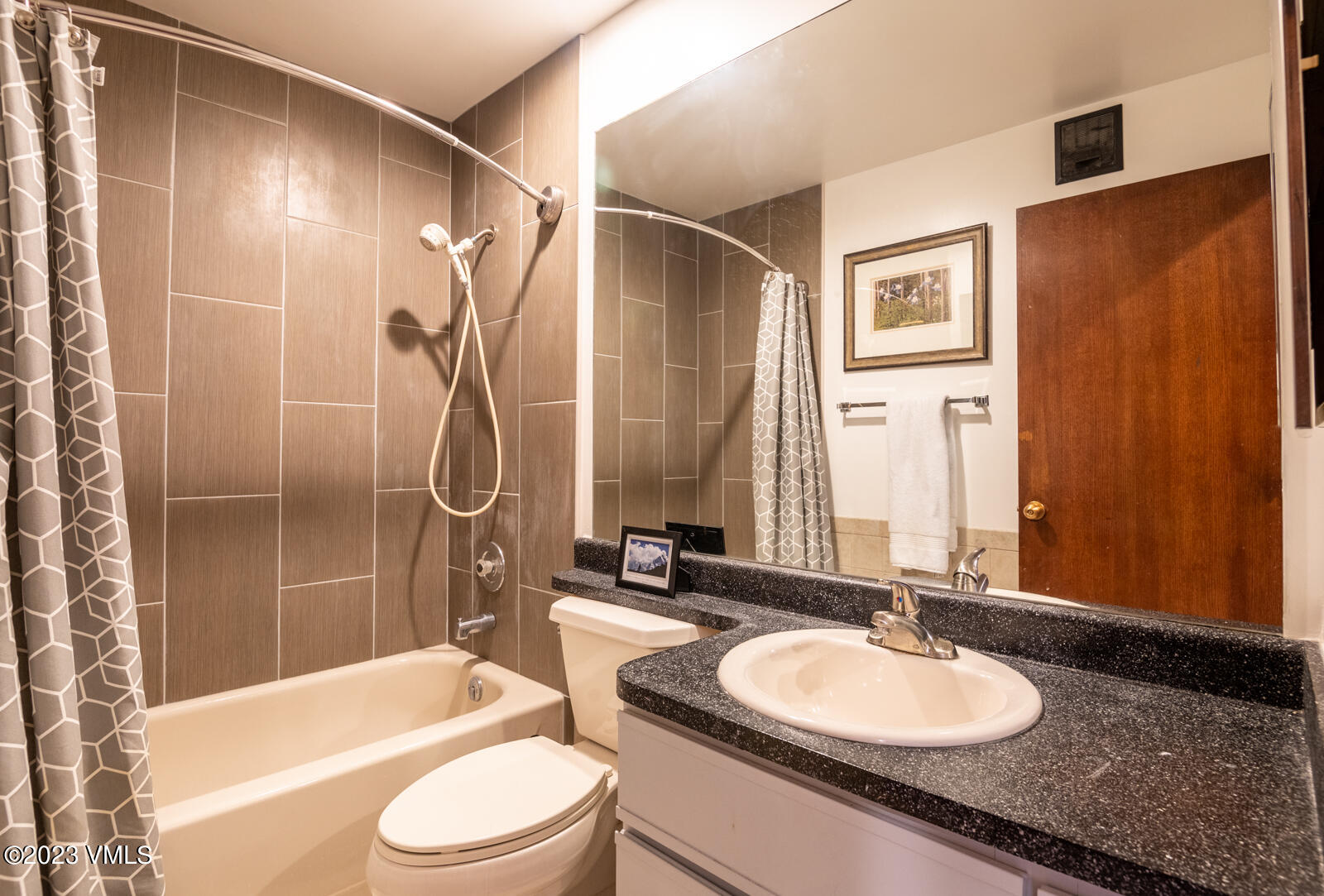 137 Benchmark Road, Unit 209 Avon, CO 81620 - Photo 10 of 20 a bathroom with a granite countertop sink toilet tub and shower