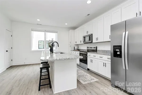 a kitchen with a sink appliances and cabinets