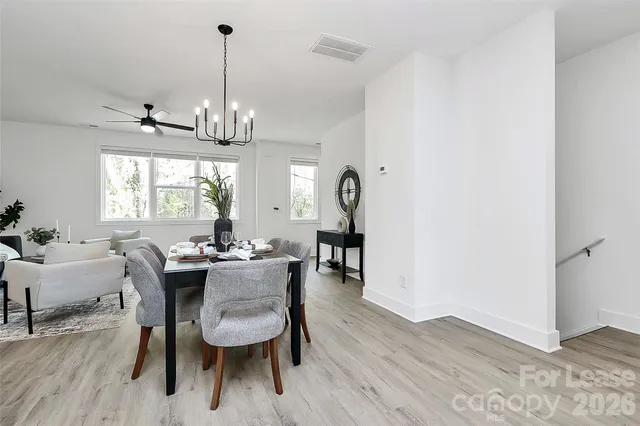 a view of a dining room with furniture window and wooden floor