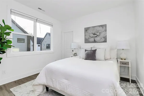 a bedroom with a large bed and a window