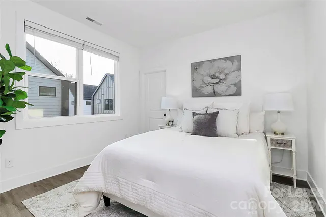 a bedroom with a large bed and a window