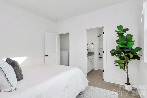 a bedroom with a bed and a potted plant
