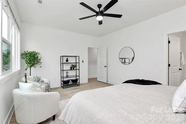 a bedroom with a bed and a chandelier