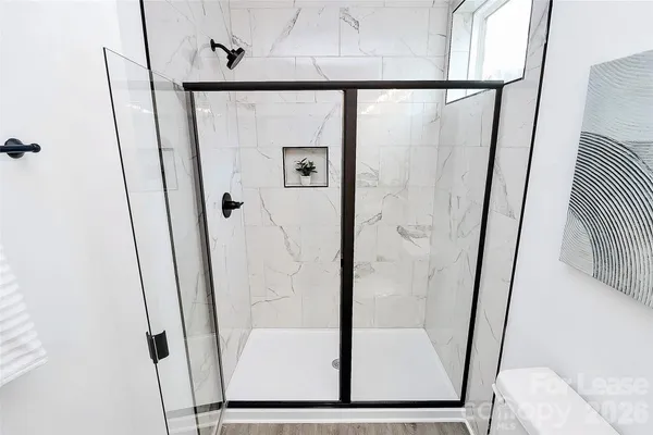 a bathroom with a shower and a mirror