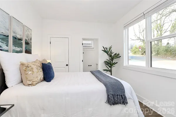 a bedroom with a large bed and a window