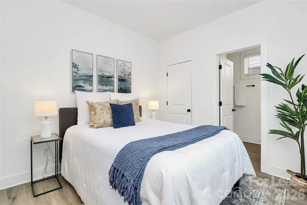 a bedroom with bed and large window