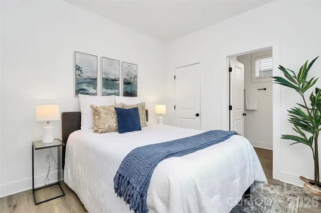 a bedroom with bed and large window