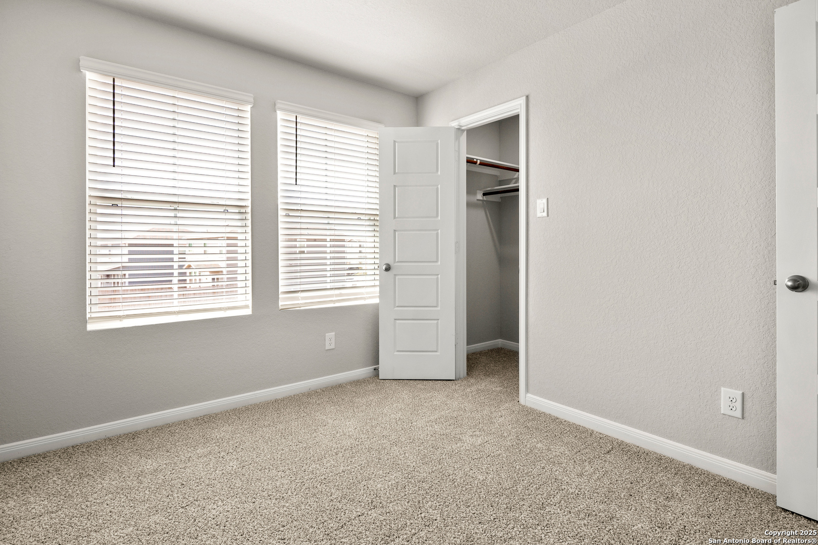 3928 Abbott Pass, Unit 101 St. Hedwig, TX 78152 - Photo 9 of 17 an empty room with windows and closet