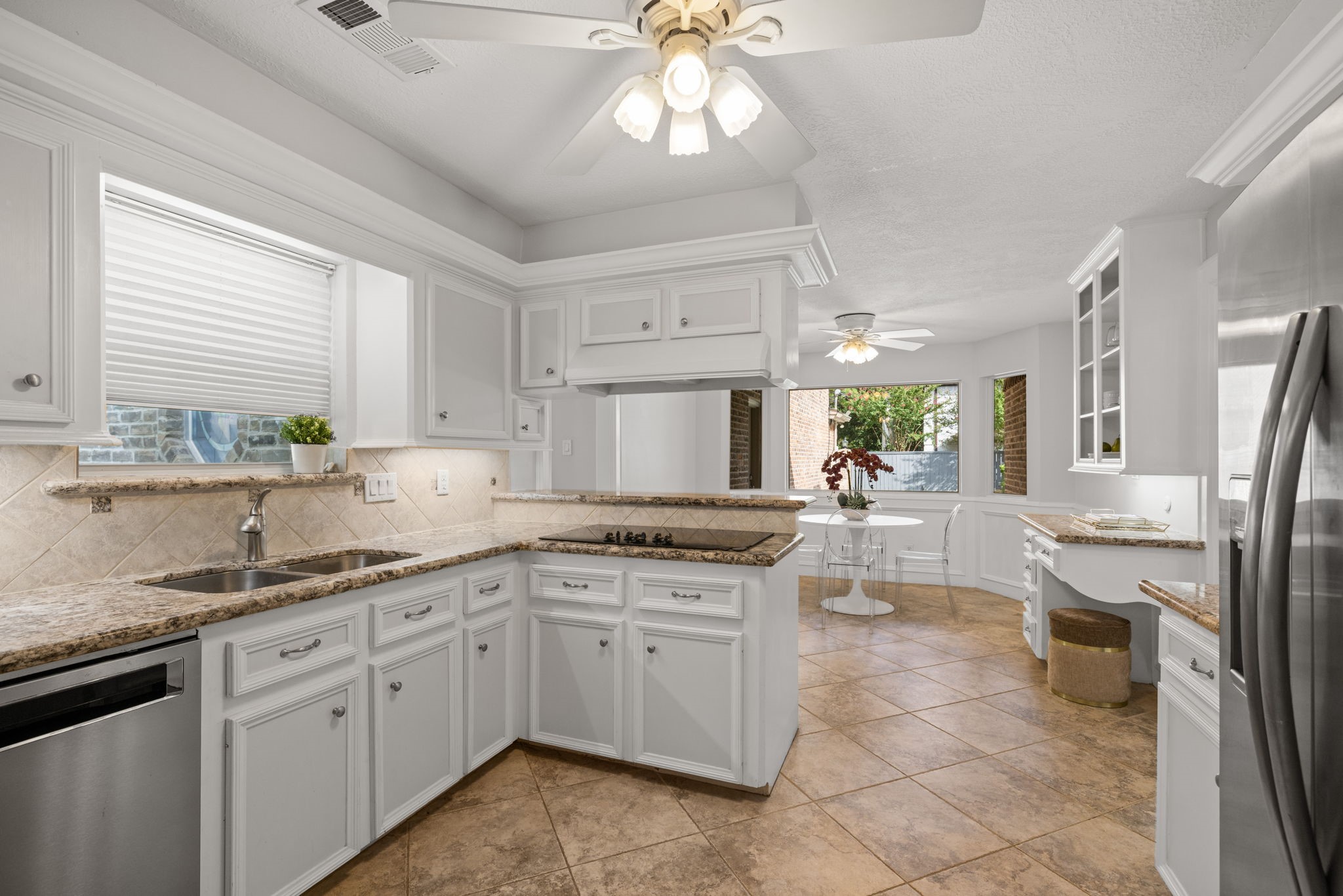 9203 Godstone Lane Spring, TX 77379 - Photo 15 of 49 The open concept Kitchen and Breakfast area measures 24 x 11 and is adjacent to the Dining Room, Guest Bath, 3-Car Garage, Laundry Room and return stairs which lead directly to the 2nd floor Game / Media Room.