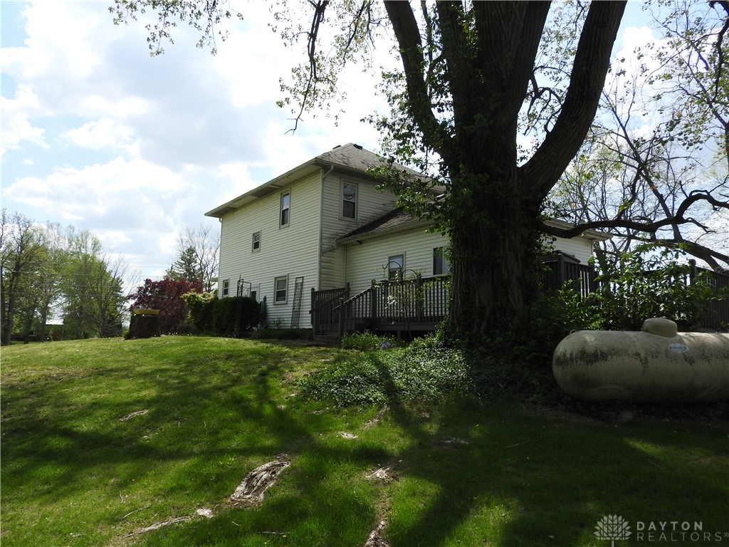 2105 East Loy Road Piqua, OH 45356 - Photo 8 of 26 This charming residence is nestled among mature trees on a sprawling green lot.
