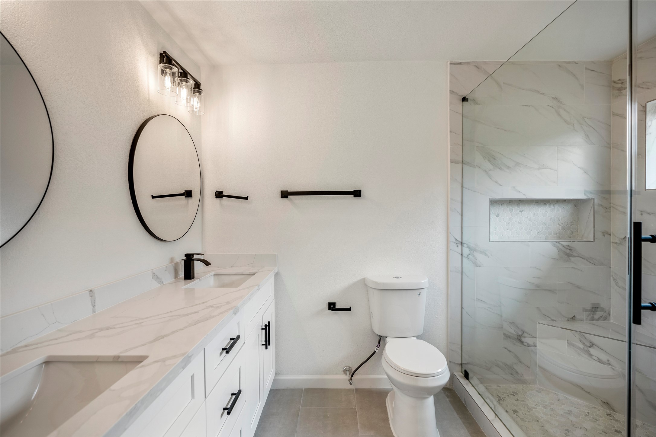 3923 Alsace Street Houston, TX 77021 - Photo 16 of 28 a bathroom with a double vanity sink toilet and a mirror