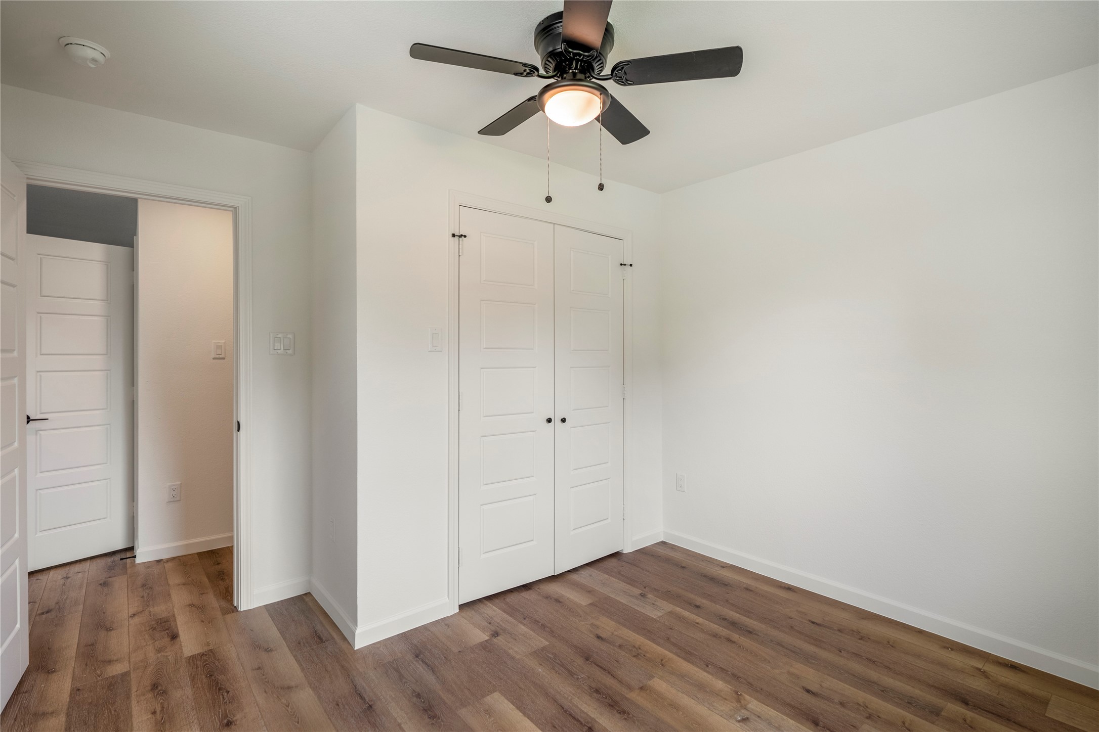 3923 Alsace Street Houston, TX 77021 - Photo 21 of 28 an empty room with wooden floor ceiling fan and window