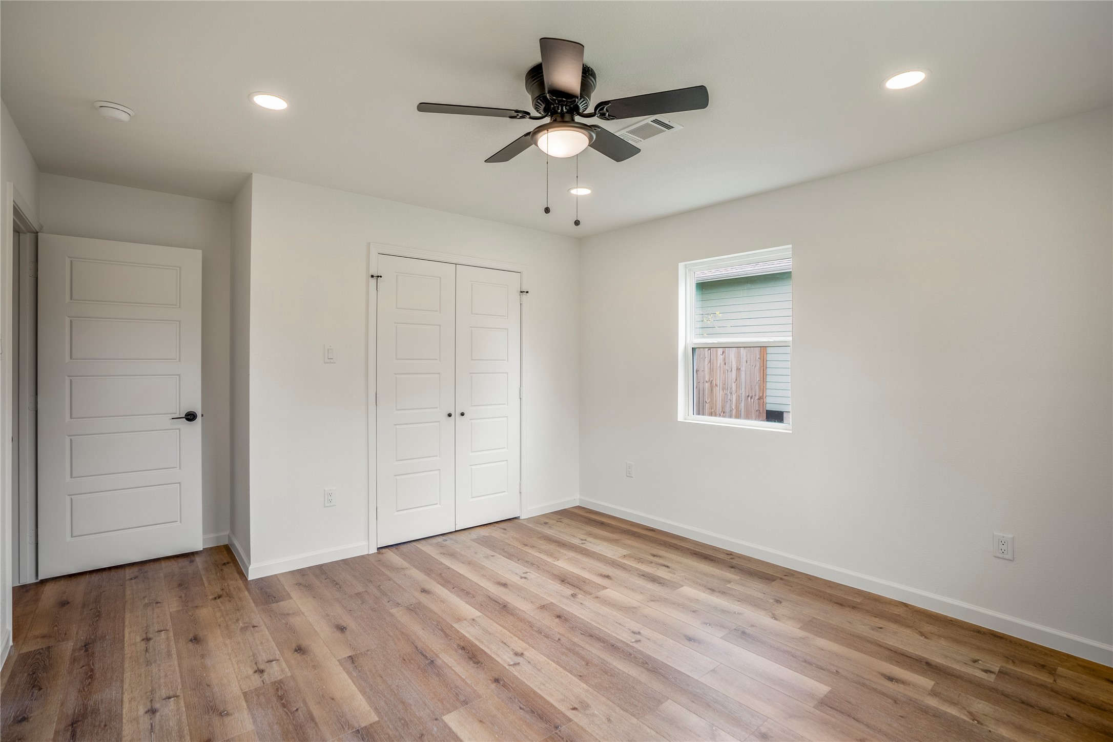 3923 Alsace Street Houston, TX 77021 - Photo 23 of 28 wooden floor in an empty room with a fan