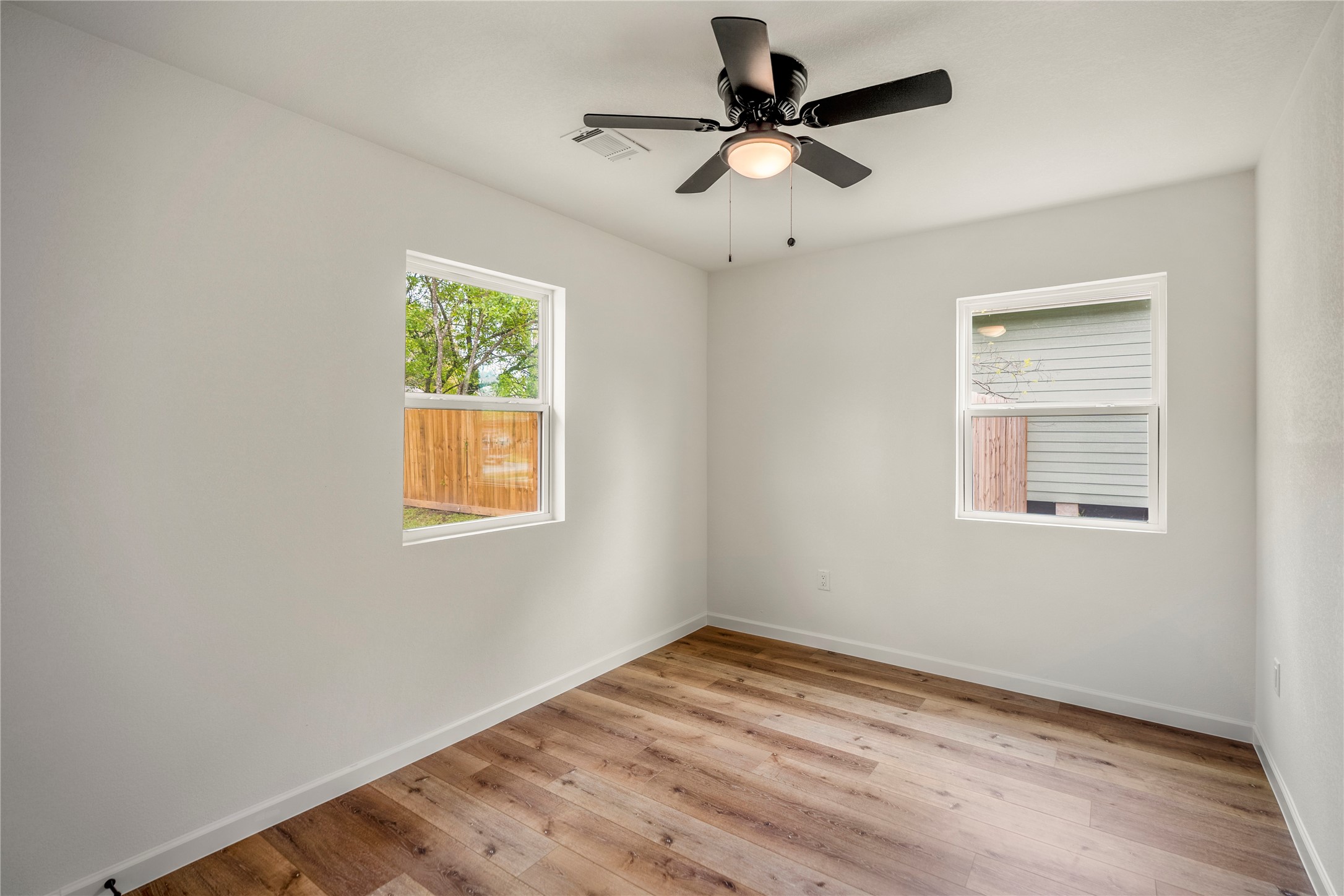 3923 Alsace Street Houston, TX 77021 - Photo 26 of 28 a view of empty room with wooden floor and fan