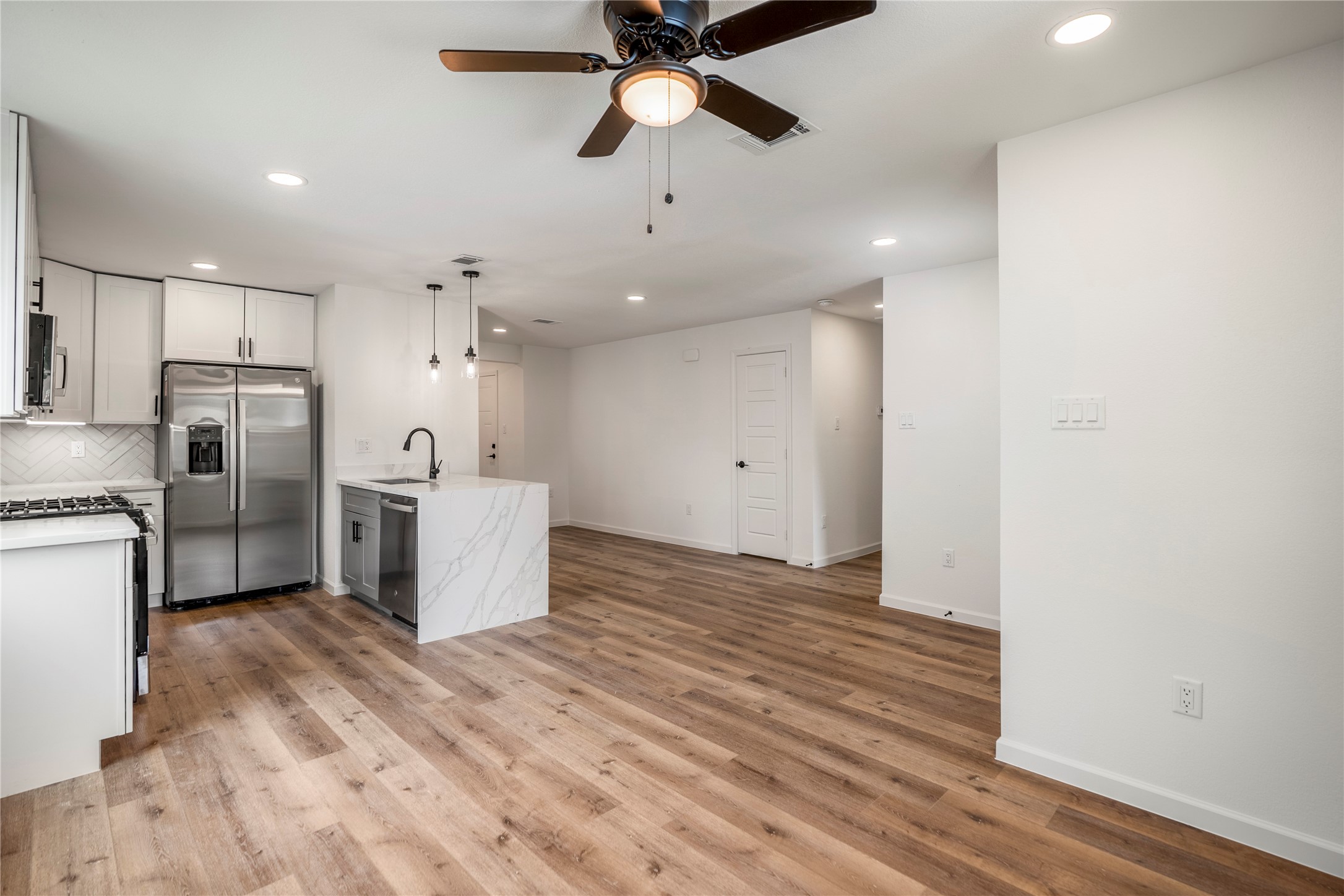 3923 Alsace Street Houston, TX 77021 - Photo 6 of 28 a kitchen with stainless steel appliances a refrigerator and a ceiling fan