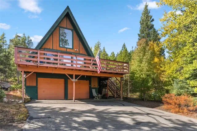 a view of a house with a garage and a car parked