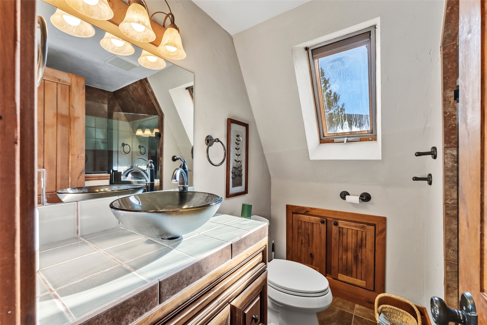 511 Vail Circle Dillon, CO 80435 - Photo 16 of 47 a bathroom with a granite countertop toilet a sink and a mirror
