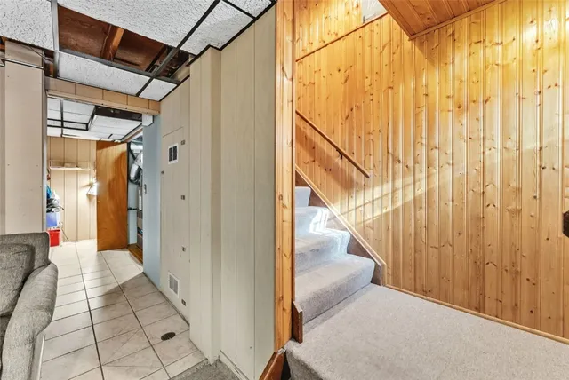 a living room with furniture a flat screen tv and a large window