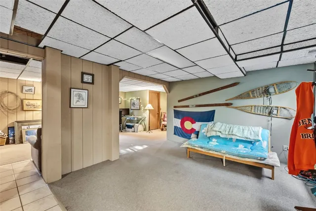 a kitchen with stainless steel appliances a refrigerator a stove a sink dishwasher and a dining table with wooden floor