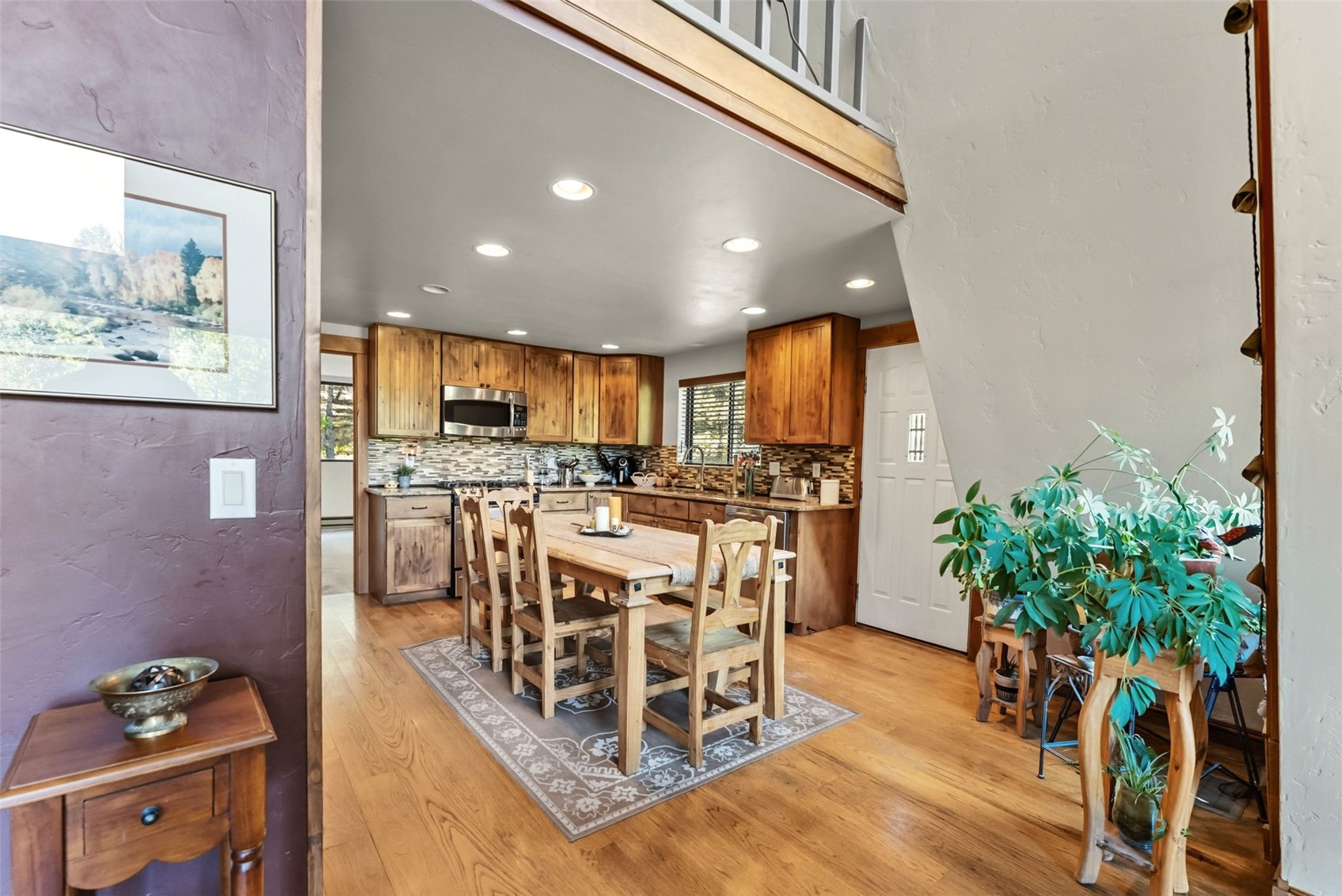 511 Vail Circle Dillon, CO 80435 - Photo 9 of 47 a view of a dining room with furniture a potted plant and wooden floor