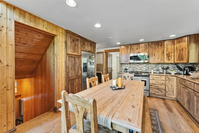 a bedroom with a bed and a lamp on the dresser