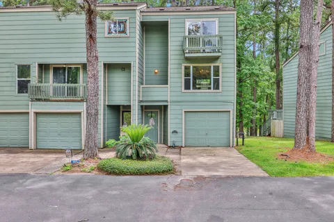 a front view of a house with a garden and plants
