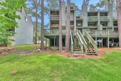 a view of a wooden deck with chairs