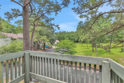 a view of a wooden deck and a forest
