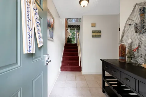 a view of a hallway with furniture and stairs