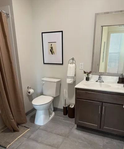 a bathroom with a sink toilet and mirror