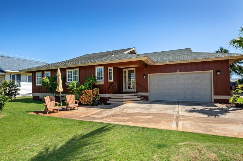 4526 Alae Road, Unit A Kekaha, HI 96752 - Photo 1 of 26 a view of a house with backyard sitting area and garden