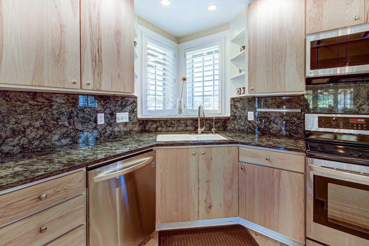 4526 Alae Road, Unit A Kekaha, HI 96752 - Photo 11 of 26 a kitchen with stainless steel appliances granite countertop a sink a stove and cabinets
